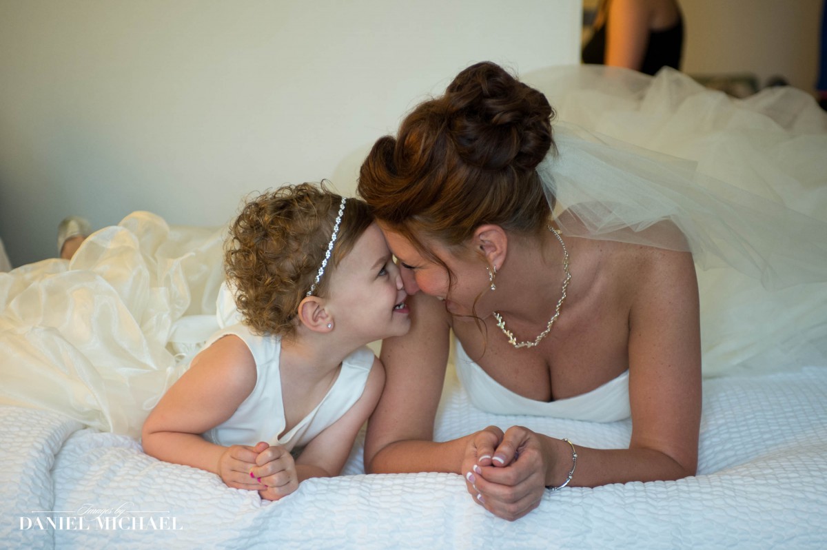 Bride and Flower Girl on Bed Wedding Photo
