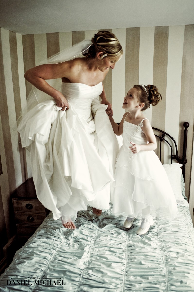 Bride and Flower Girl Jumping on Bed