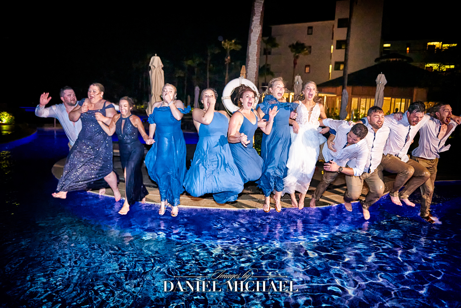 Destination Wedding Party Jumping in Pool