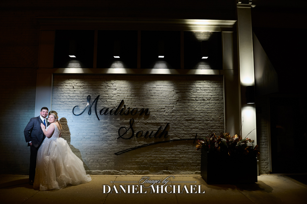 Couple standing in front of "Madison South" wall sign