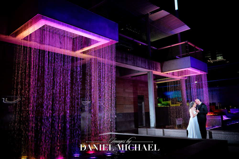 Couple standing our rainfall fountains