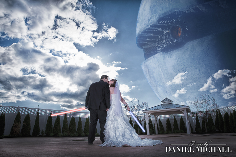 Couple kissing holding lightsabers with Death Star in sky