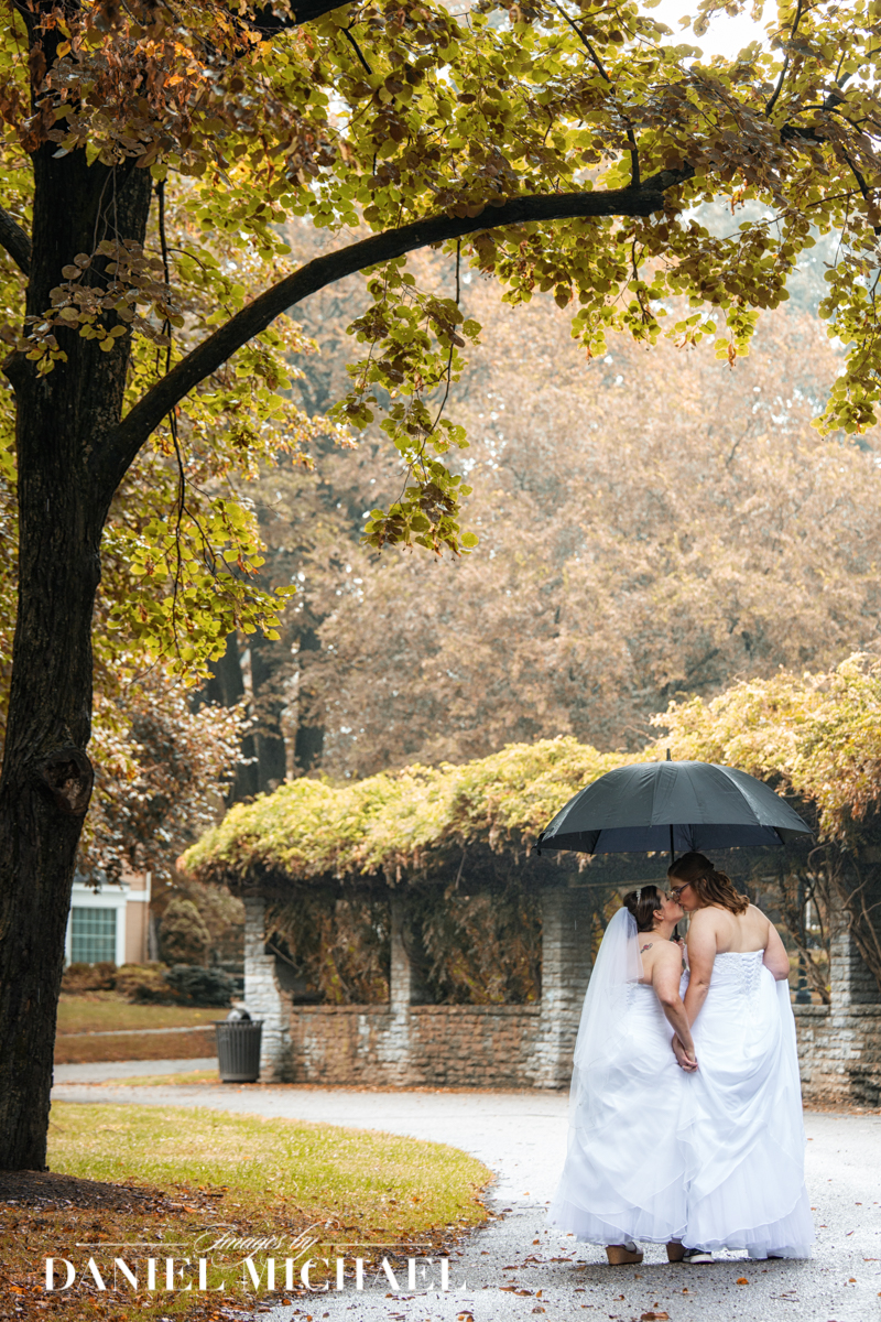 LGBTQ+ Lesbian Couple Wedding Photo in Rain with Umbrella