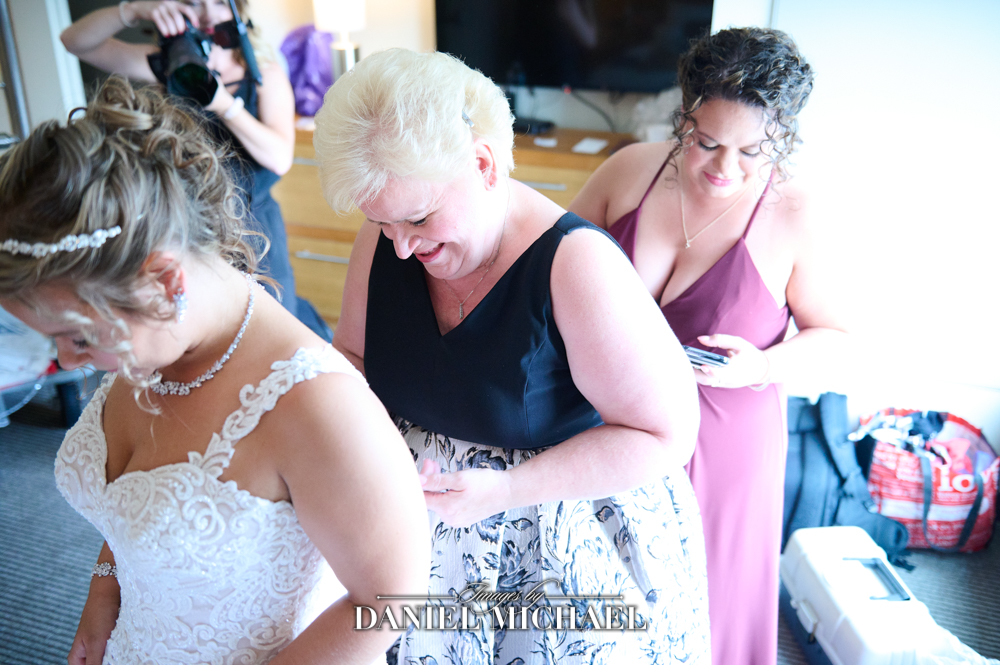 Mom and Sister Helping Bride into Dress